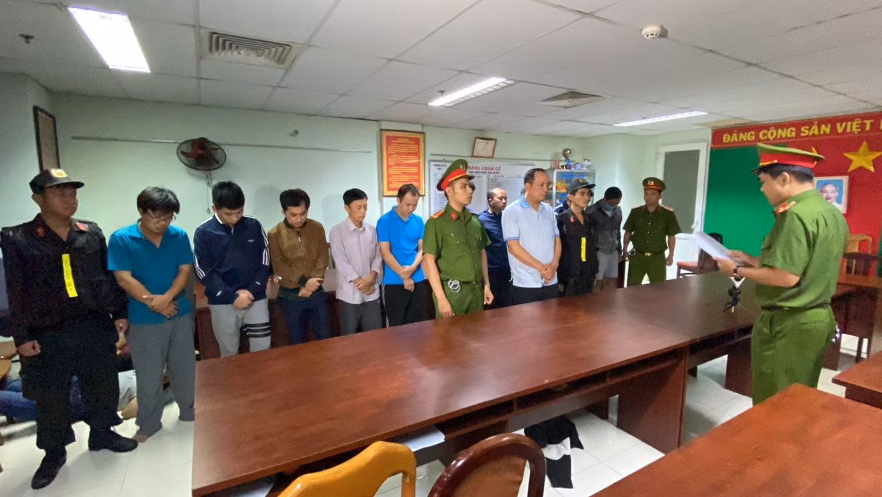 Cơ quan CSĐT Công an TPHCM tống đạt quyết định khởi tố bị can và lệnh bắt tạm giam 11 người của trung tâm Đăng kiểm 50-05V. Ảnh: Công an cung cấp
