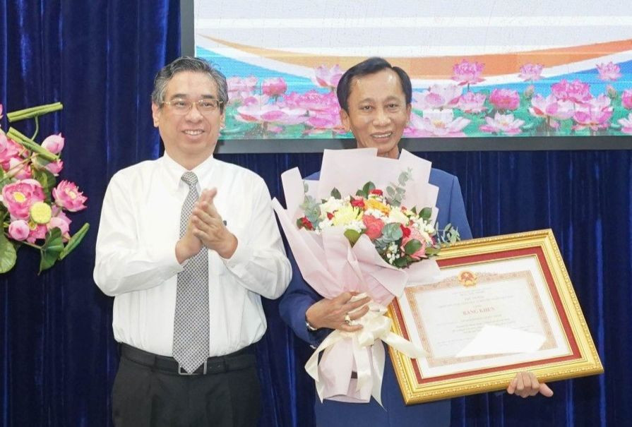 Phó Bí thư Thành ủy TPHCM Nguyễn Phước Lộc trao Bằng khen Thủ tướng Chính phủ cho ông Lê Đức Thịnh. Ảnh: Thuận Văn.