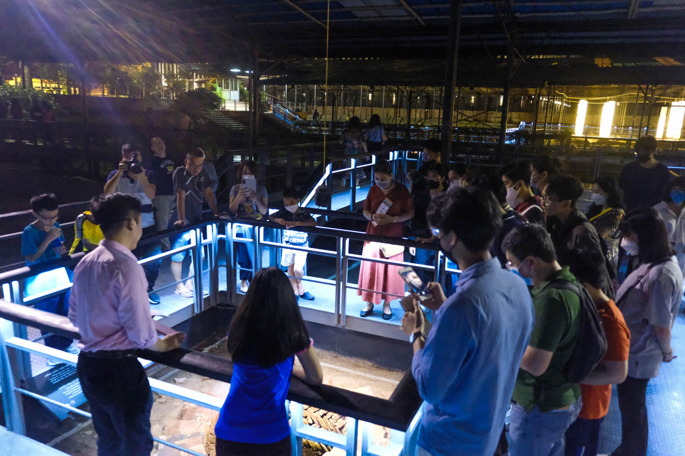 Du khách lắng nghe thuyết minh tại giếng xương cá