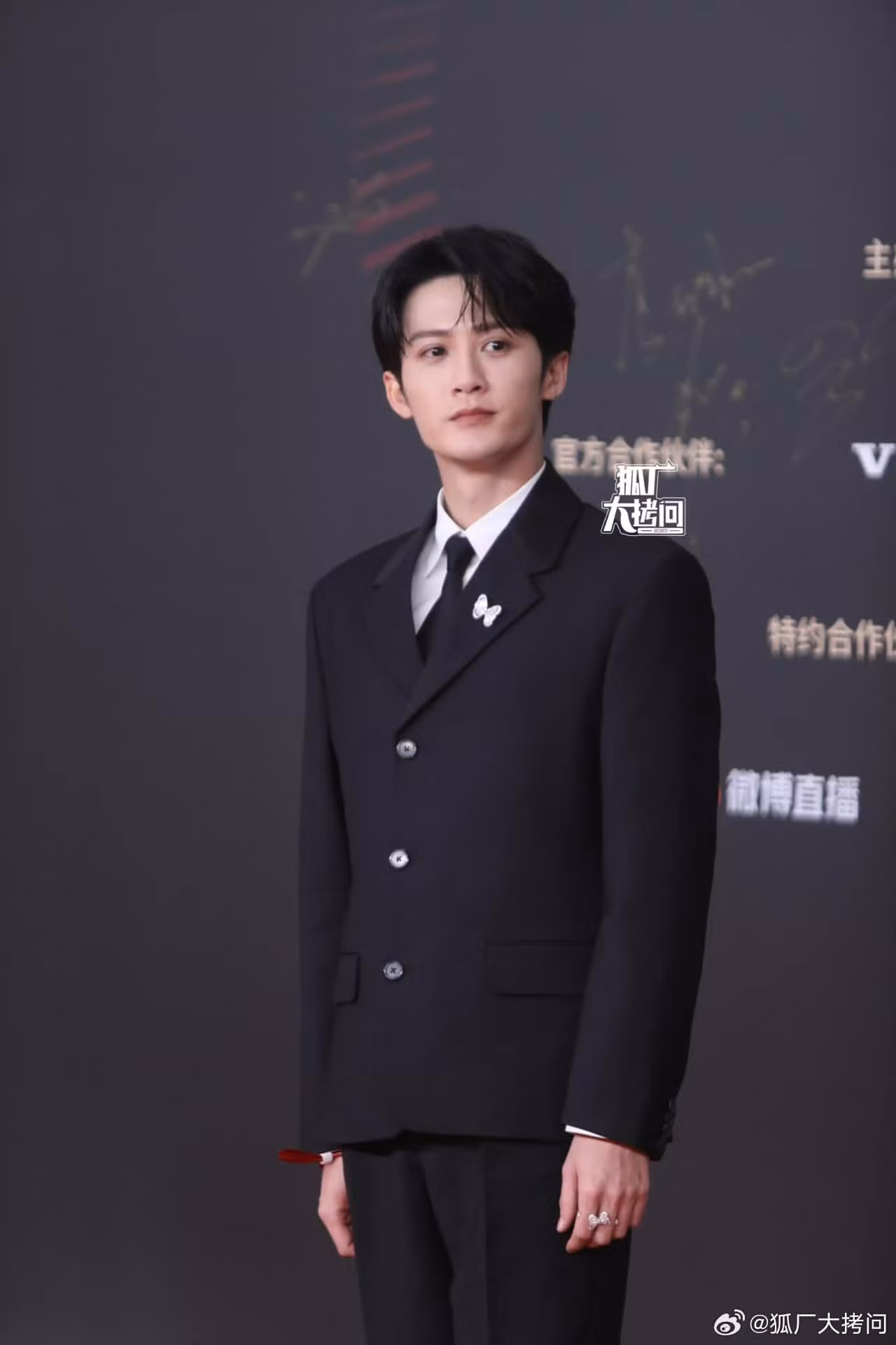 Đàn Kiện Thứ điển trai với bộ suit đen cơ bản.