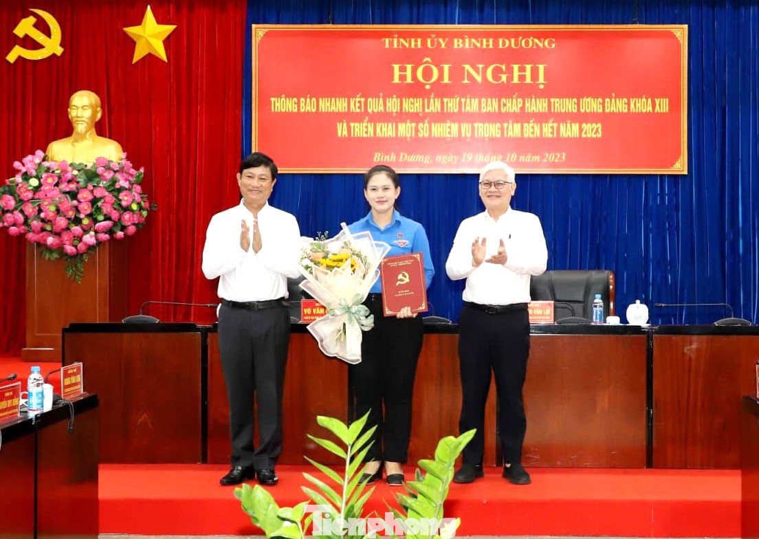 Bí thư Tỉnh ủy Bình Dương Nguyễn Văn Lợi (ngoài cùng bìa phải) và Chủ tịch UBND tỉnh Bình Dương Võ Văn Minh (bìa trái) trao quyết định cho bà Trần Thị Diễm Trinh (giữa)