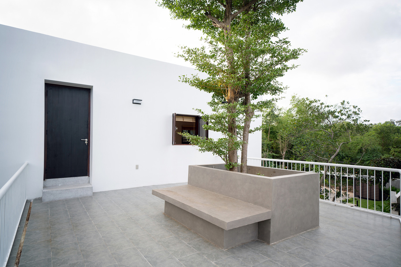 Đội ngũ KTS đã trồng một cây lớn có bóng mát ở tầng trệt xuyên qua ban công tầng trên để làm mát cả hai khu vực vào mùa hè.