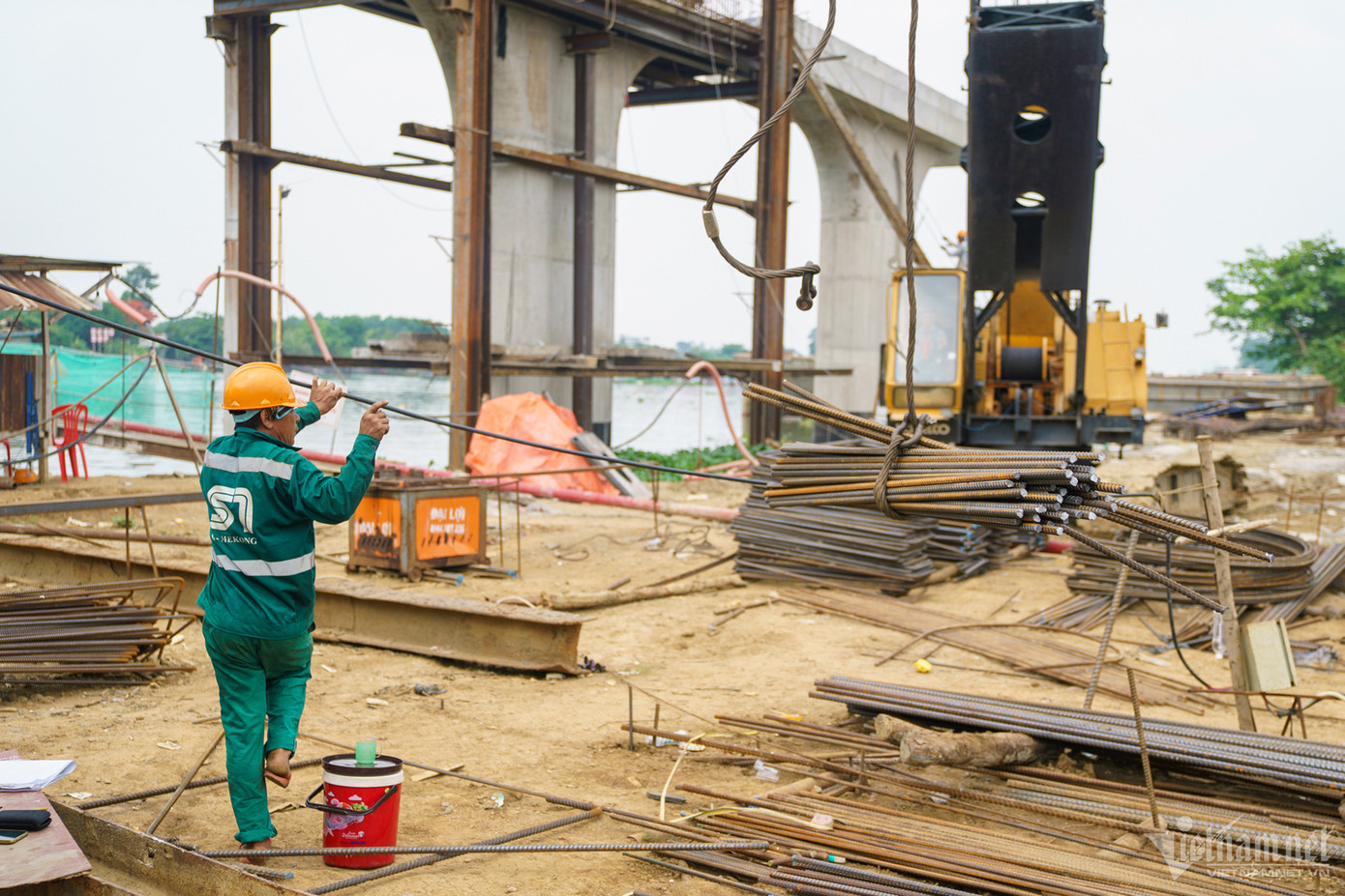 Những ngày này, trên công trường, các kỹ sư và công nhân tất bật làm việc ở hạng mục cầu chính. Tuy nhiên, do vướng mặt bằng, ở một số vị trí, máy móc vẫn tiếp tục nằm chờ.
