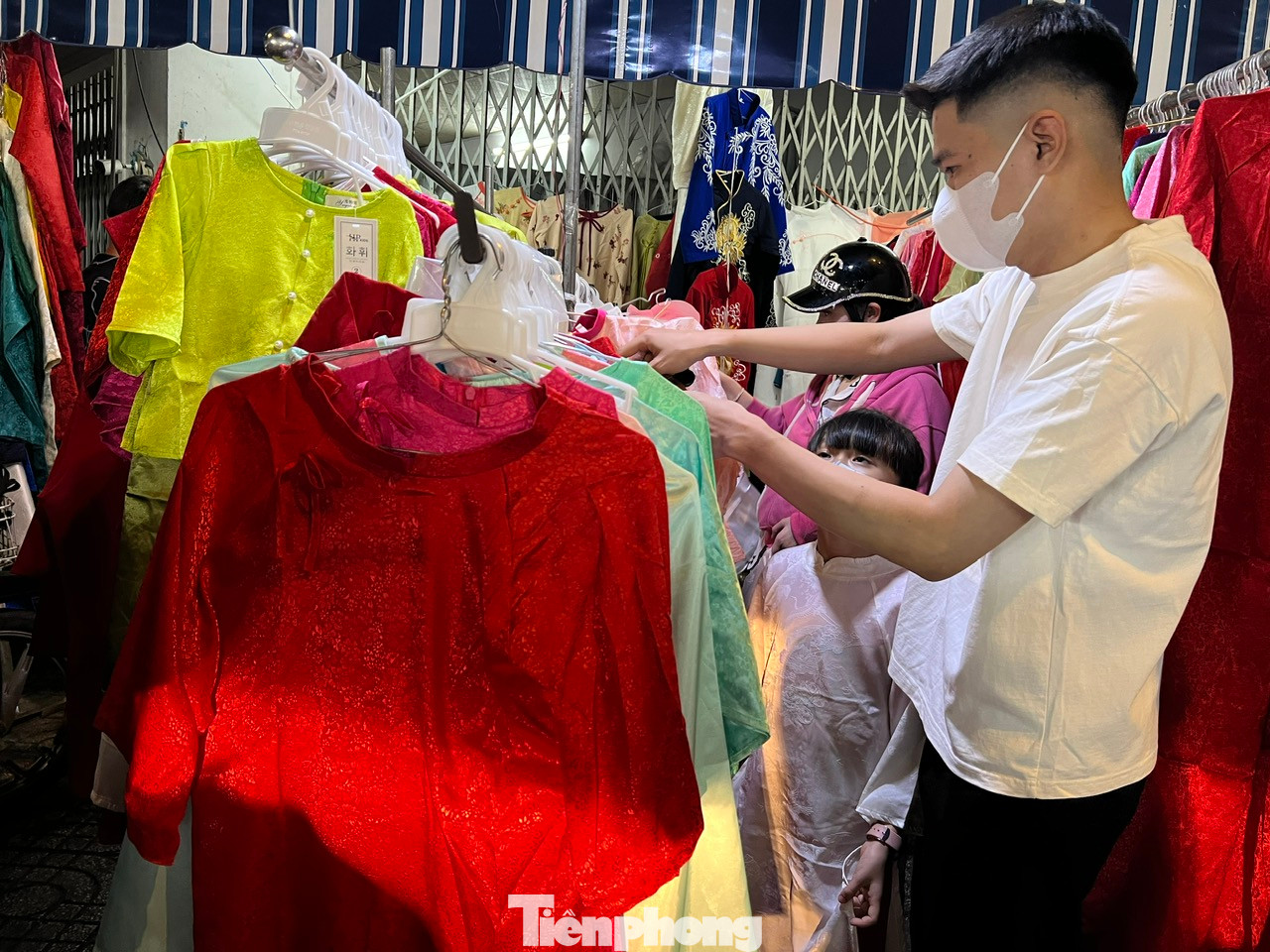 Một quầy hàng kinh doanh áo dài hiếm hoi có nhiều khách đến xem và chọn mua. Giá áo dài ở đây rất "mềm", chỉ từ 350.000 - 650.000 đồng/bộ. Khách mua 2 - 3 bộ còn được giảm giá thêm.