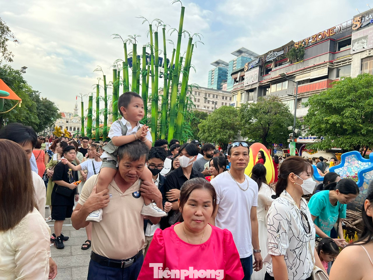 Nườm nượp khách đổ về khu vực trung tâm TPHCM để vui chơi, trẻ em được bố mẹ cõng trên vai để khỏi lạc vì dòng người càng lúc càng đông.