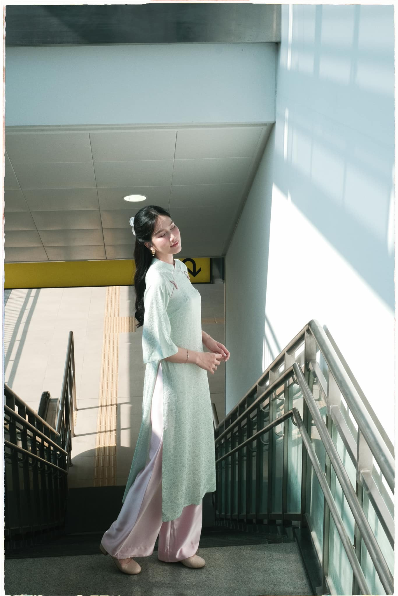 Á hậu Phương Anh ưa chuộng áo dài dáng suông, gam màu pastel nhẹ nhàng. Cô phối cùng phụ kiện giày bệt, kẹp tóc mang phong cách vintage.