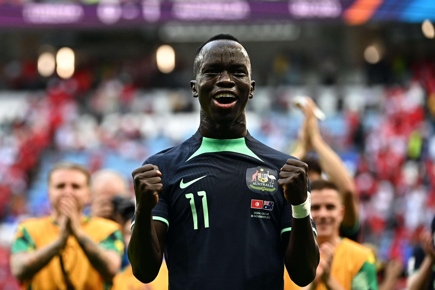 Awer Mabil ăn mừng chiến thắng trước Tunisia. Ảnh: AFP