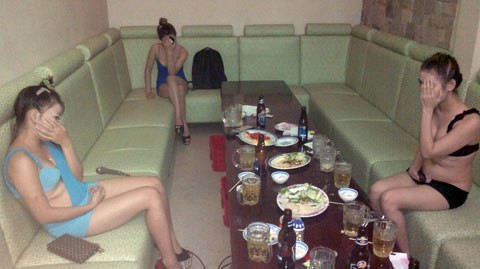 Tiếp viên mặc bikini ngồi tiếp bia khách trong quán karaoke. Ảnh: Q.T. Tiếp viên mặc bikini ngồi tiếp bia khách trong quán karaoke. Ảnh: Q.T