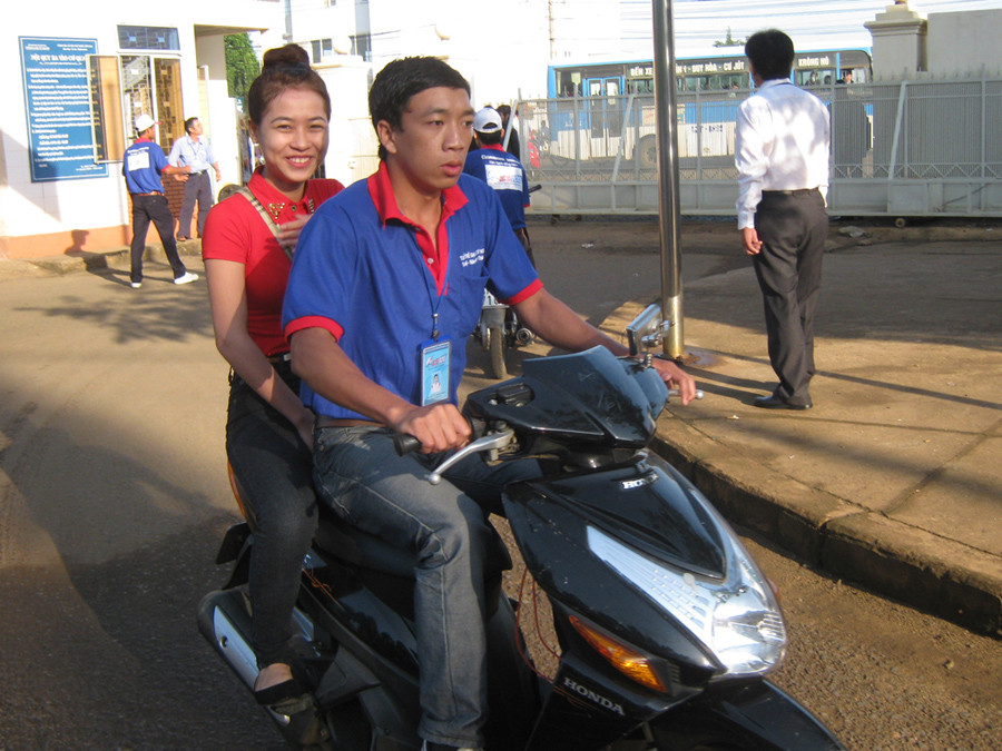 Thanh niên tình nguyện dùng xe máy chở thí sinh vào tận phòng thi. Ảnh: Lê Kiến