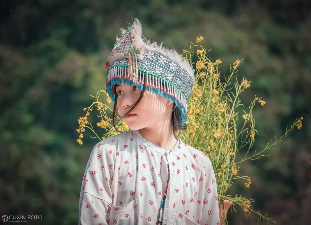 Nét mặt trong trẻo và sau lưng là những bó hoa rừng - Ảnh: NVCC Nét mặt trong trẻo và sau lưng là những bó hoa rừng - Ảnh: NVCC