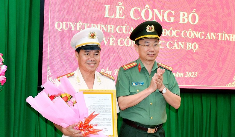 Đại tá Trương Sơn Lâm, Giám đốc Công an tỉnh Bến Tre trao quyết định và chúc mừng Đại tá Lê Văn Hiền. Ảnh: Chinhphu.vn.
