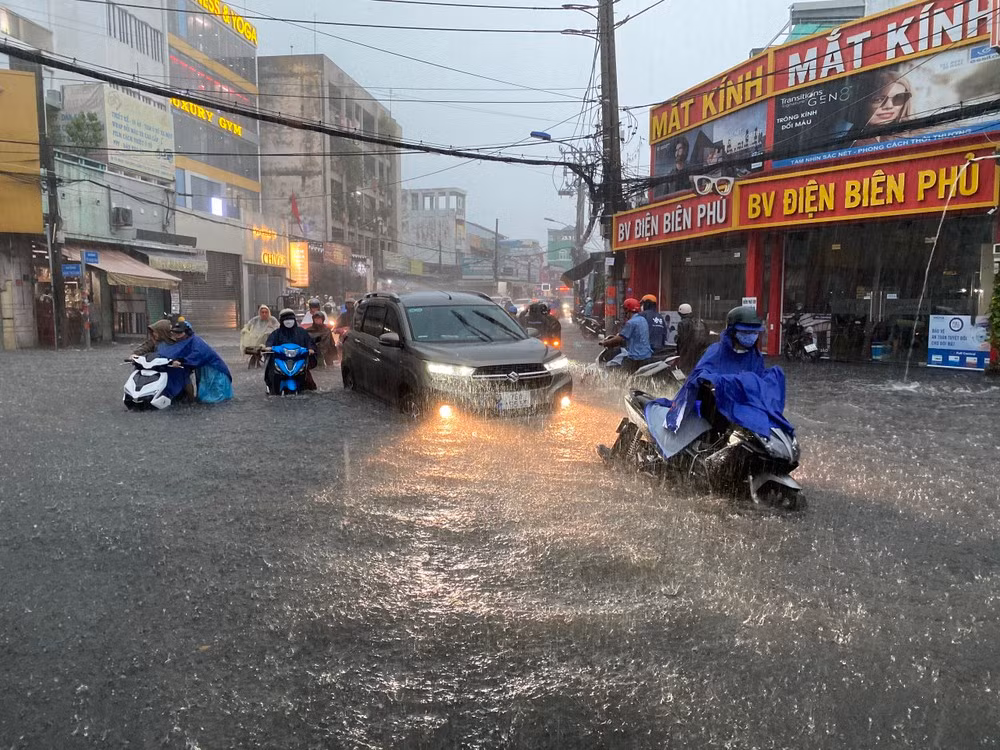 Người dân TPHCM di chuyển khó khăn trong cơn mưa lớn Người dân TPHCM di chuyển khó khăn trong cơn mưa lớn