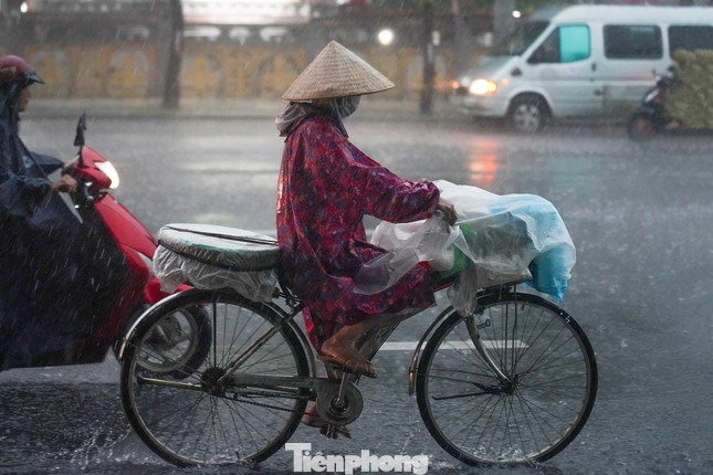 Người dân TPHCM di chuyển trong cơn mưa. Ảnh: Phạm Nguyễn Người dân TPHCM di chuyển trong cơn mưa. Ảnh: Phạm Nguyễn