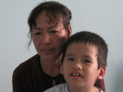 Bà Hoa ôm con kêu oan. ẢNH: THANH THUỶ. Bà Hoa ôm con kêu oan. ẢNH: THANH THUỶ