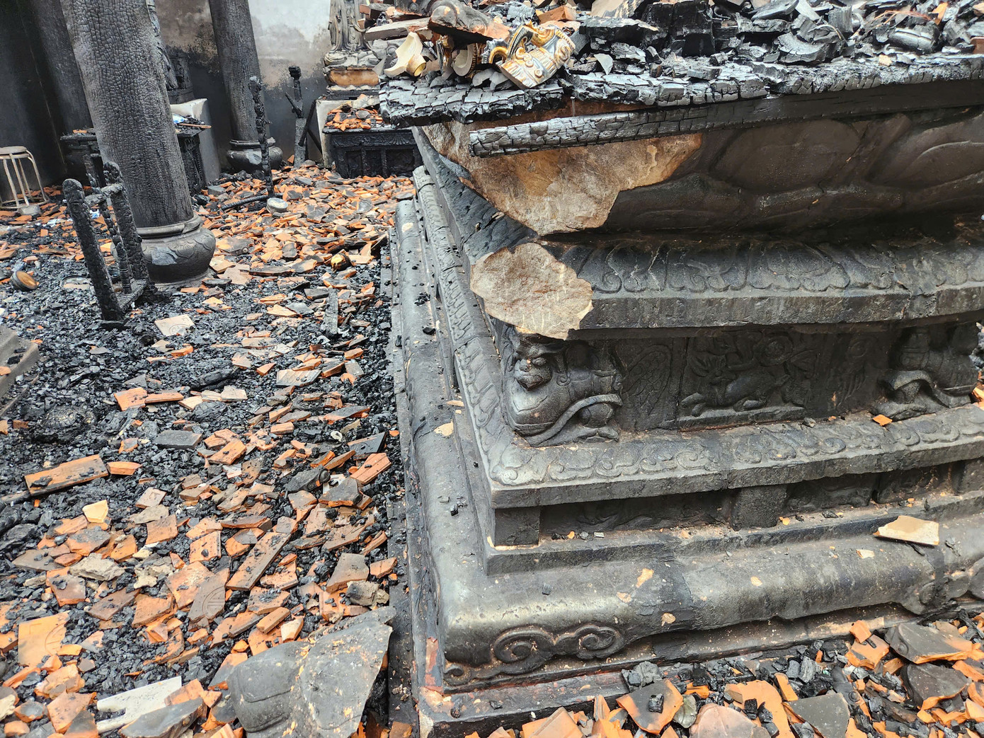 Bàn thờ Phật bằng đá hoa sen hư hại khá lớn sau vụ cháy.