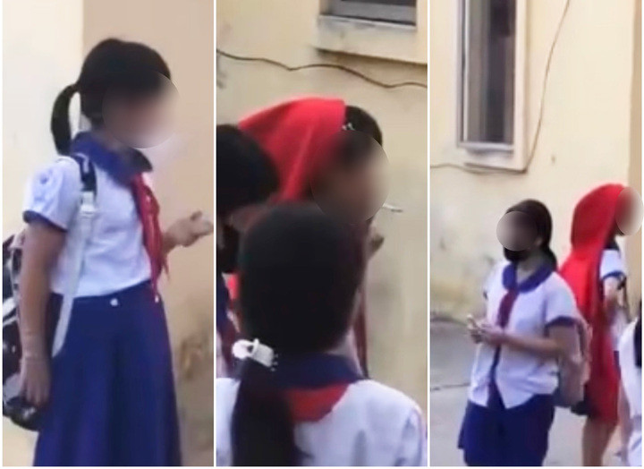 Nhóm nữ học sinh tiểu học hút thuốc trong sân trường ở An Giang. (Ảnh chụp màn hình)