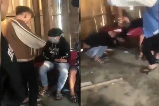 Bị hành hung, nam sinh chỉ biết ôm đầu chịu trận. (Ảnh: Cắt từ clip)