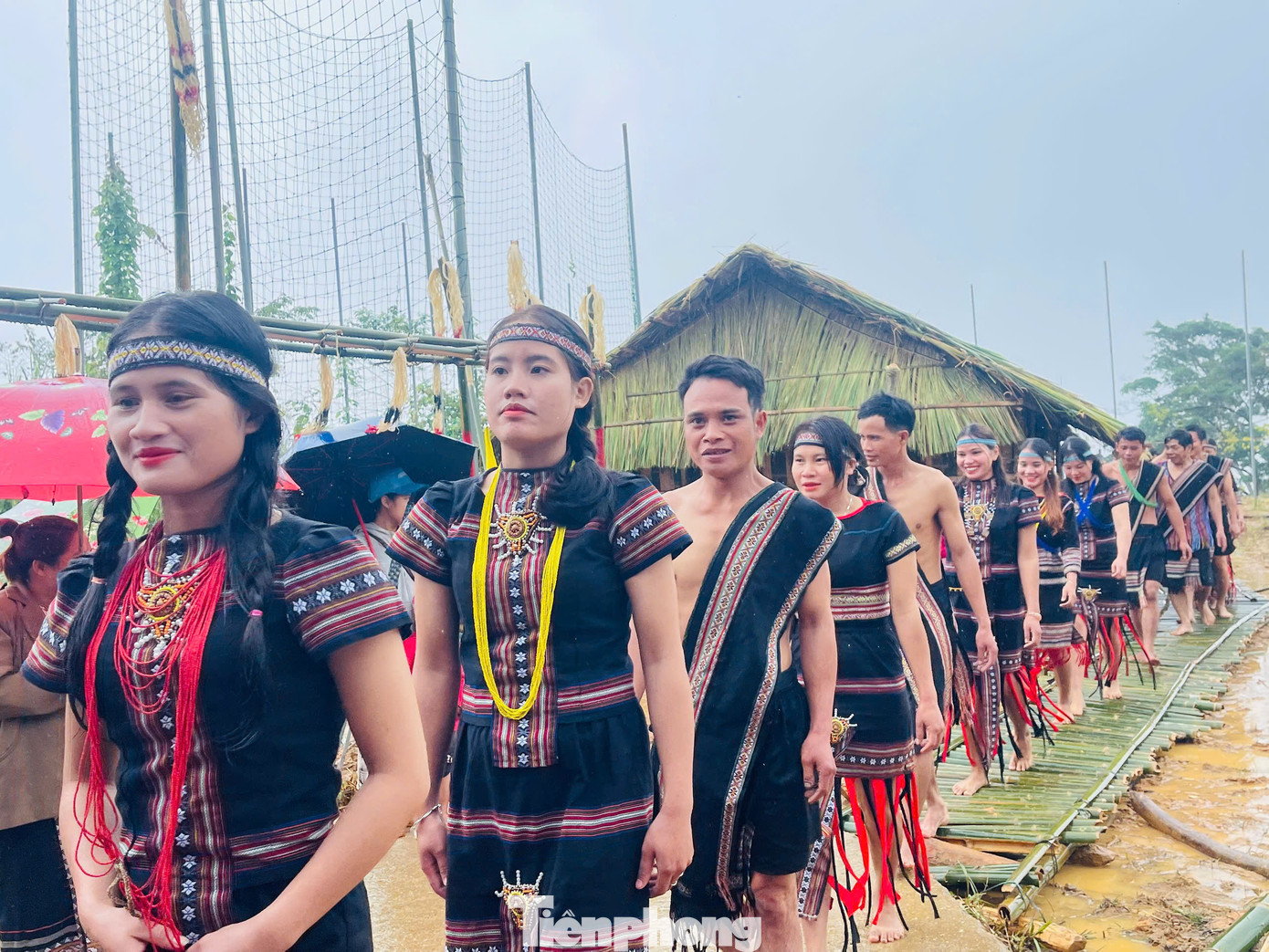 Bà con theo sau cùng khiêng các lễ vật như con heo, con gà để dâng lên thần trong lễ cúng.