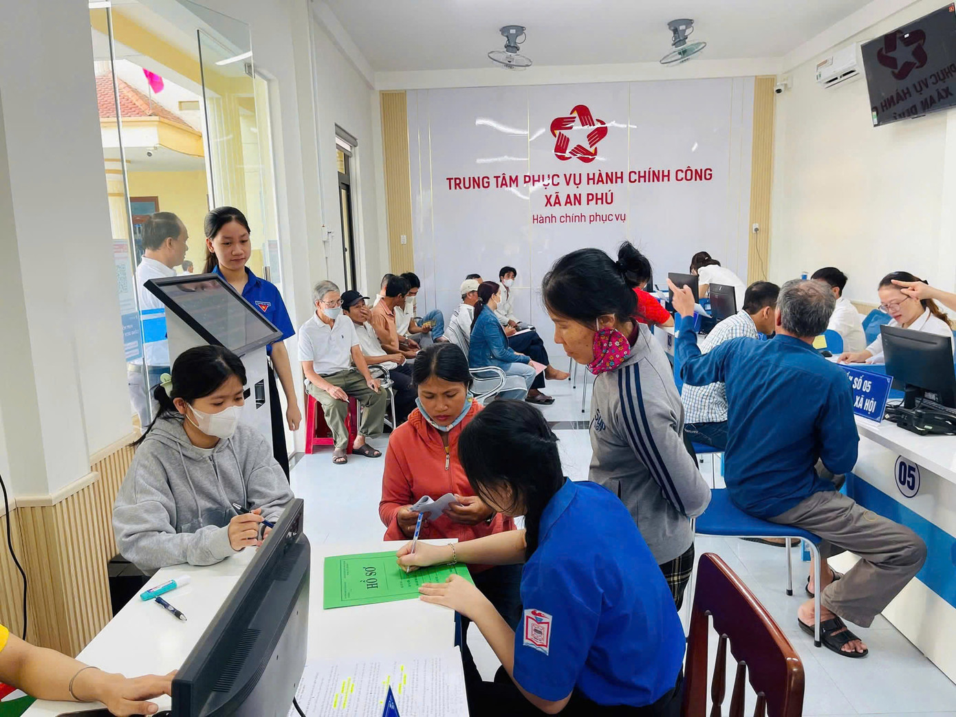Áo xanh hỗ trợ người dân đến giải quyết thủ tục hành chính tại Trung tâm phục vụ hành chính công xã An Phú (tỉnh Quảng Ngãi). Ảnh: Nguyễn Ngọc
