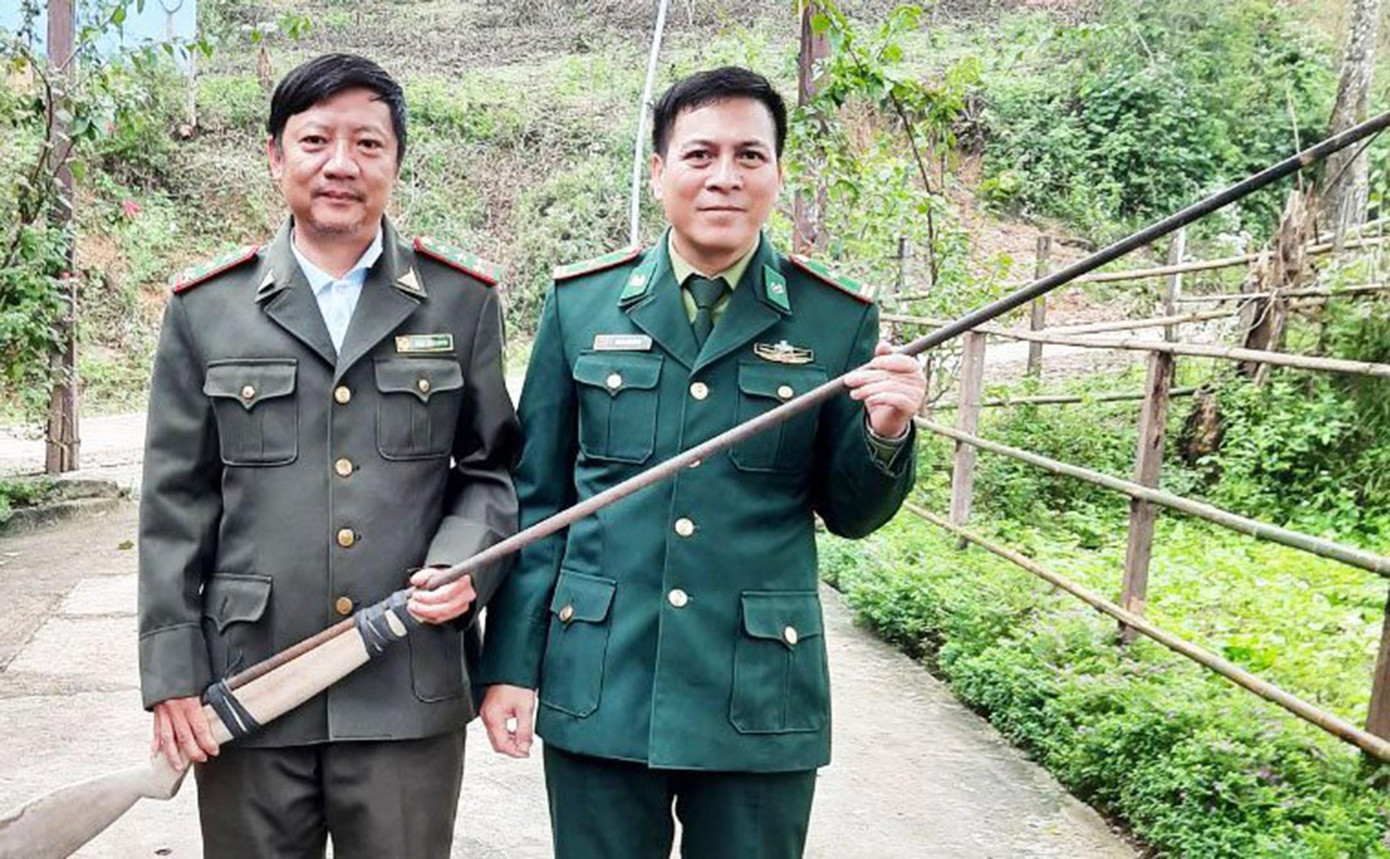 Bộ đội biên phòng Đồn Cà Xèng tiếp nhận khẩu súng săn có nòng dài gần 2 mét do người dân giao nộp - ảnh Văn Chương