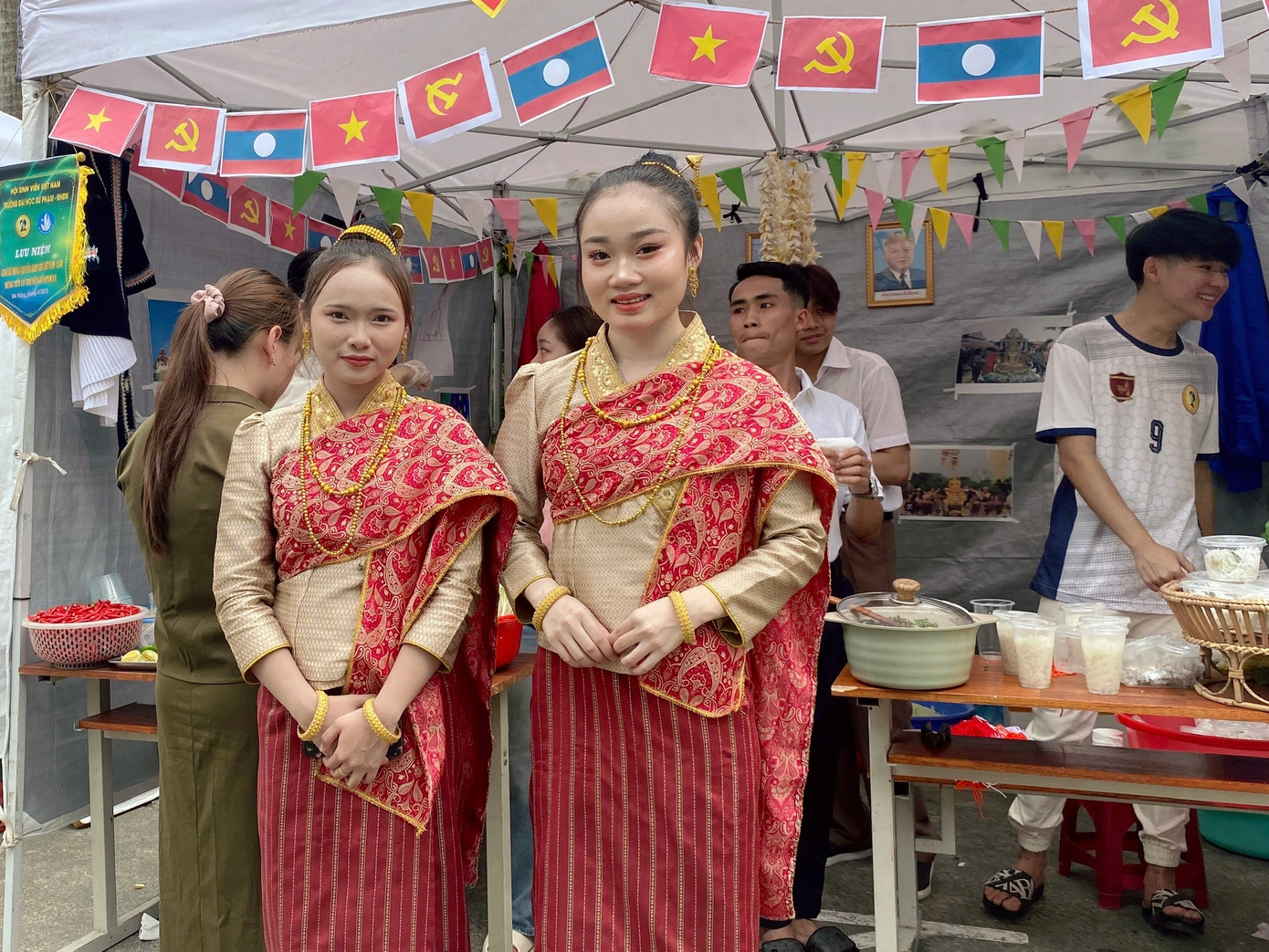 Pu (bên phải, du học sinh Lào) cho biết bạn rất vui khi vẫn được ăn Tết của quê nhà dù đang ở Việt Nam. “Đây là hoạt động vô cùng ý nghĩa đối với bản thân mình, mình vô cùng biết ơn tình cảm của nhà trường dành cho du học sinh chúng mình”, Pu bộc bạch. Ảnh: Minh Hiền