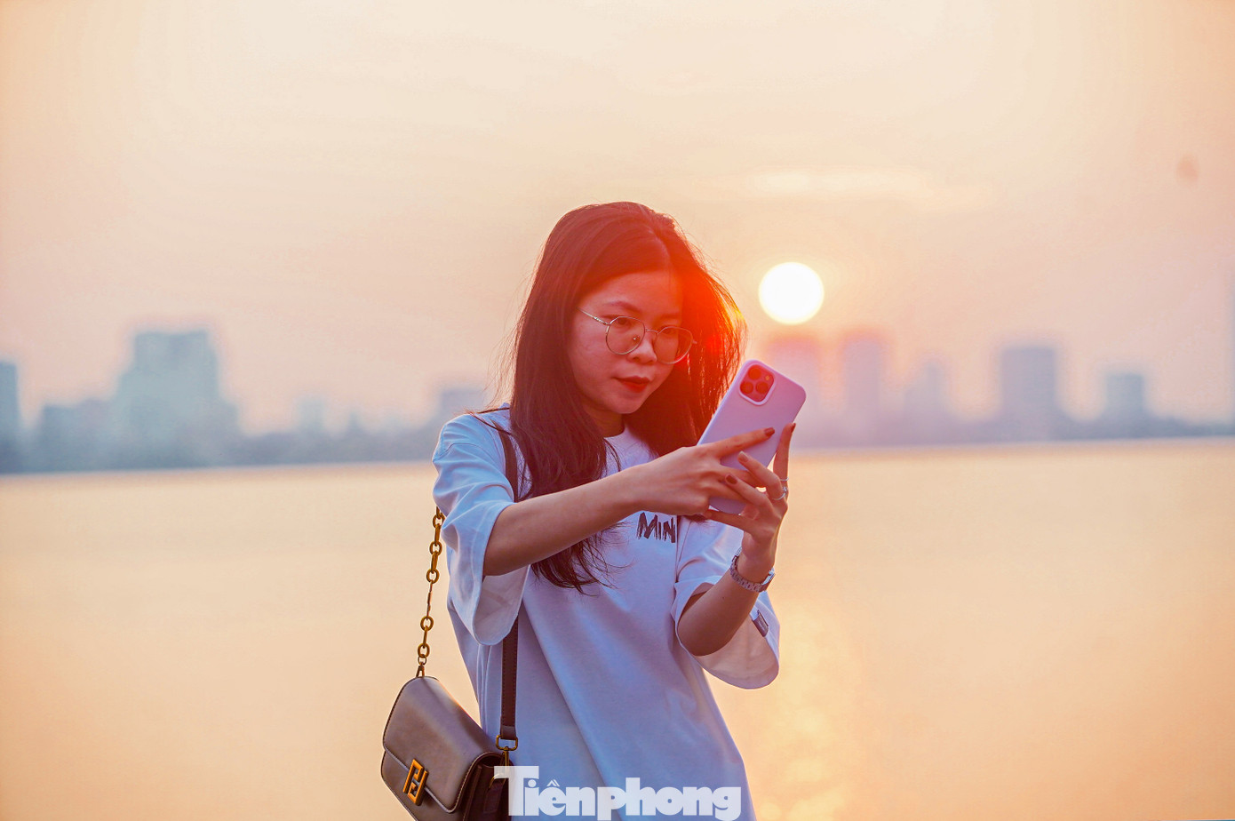 "Em bấm máy liên tục, bắt trọn từng khoảnh khắc khi mặt trời buông xuống, cứ 10 giây là màu mặt trời trở nên khác, nắng không còn gắt", bạn Hoa (Thanh Xuân, Hà Nội) chia sẻ.