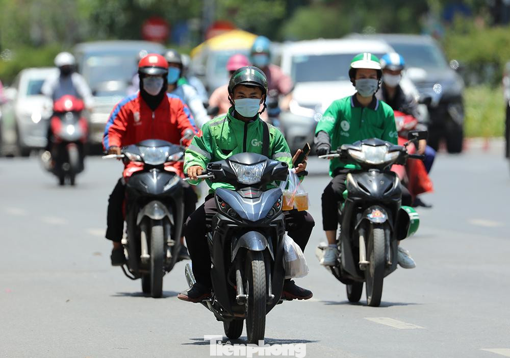 Nhiều shipper cũng kín mít áo dài tay chống nắng đi ship đồ uống cho khách