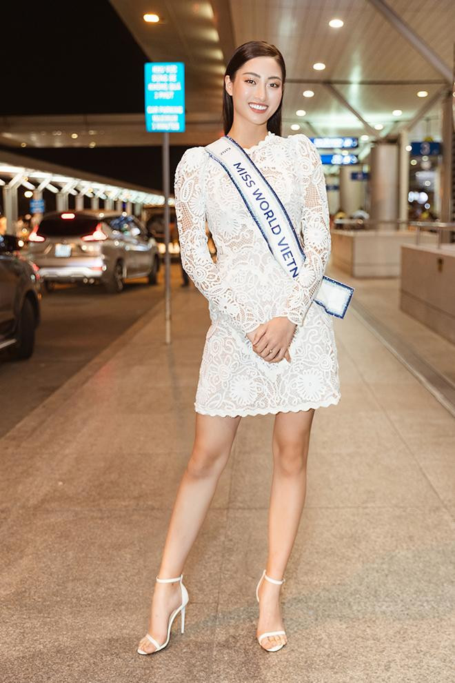 Lên đường sang Anh tham dự Miss World 2019, Hoa hậu Lương Thuỳ Linh khoe trọn đôi chân dài 1m22 'trứ danh' ở sân bay trong bộ váy ren trắng.