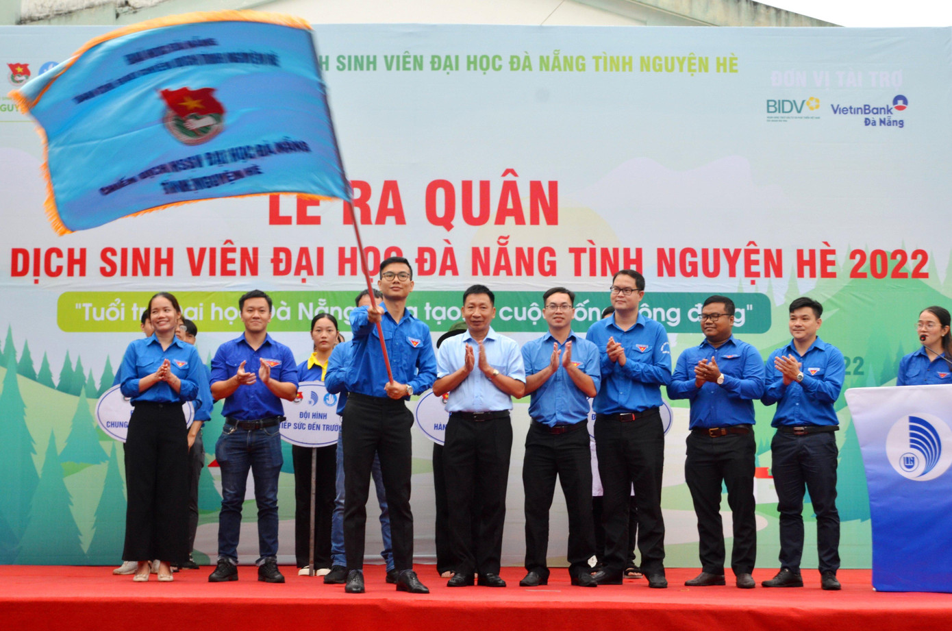 Sáng ngày 11/7, Đoàn Thanh niên - Hội Sinh viên Đại học Đà Nẵng (ĐHĐN) tổ chức Lễ Ra quân Chiến dịch sinh viên tình nguyện hè năm 2022 với chủ đề Tuổi trẻ ĐHĐN sáng tạo, tình nguyện vì cộng đồng. Trong ảnh: Lãnh đạo ĐHĐN trao cờ cho Thường trực Ban Chỉ đạo Chiến dịch.