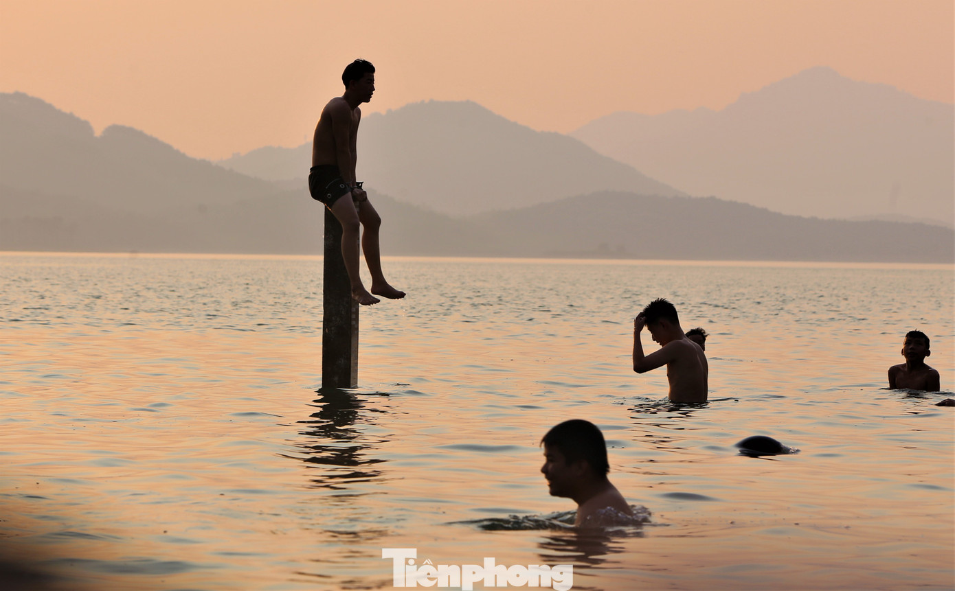 Nhiều thanh niên còn leo lên các thành cầu, trụ cầu gần cống xả để thử cảm giác mạnh.