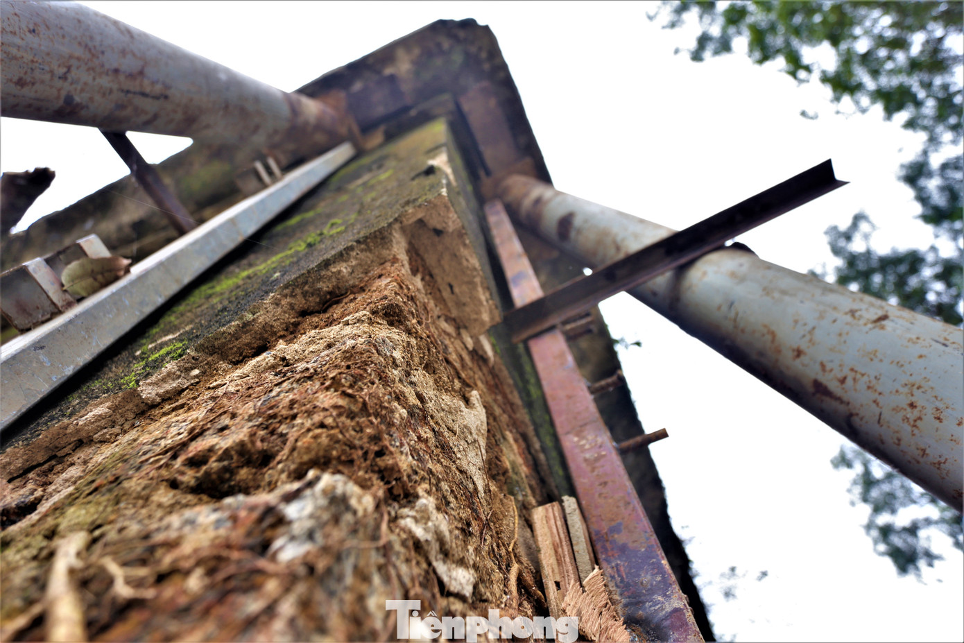 Trên đỉnh có có mái ngói, hoa văn, chữ viết. Qua thời gian, biến cố lịch sử, nhiều mảng vữa rơi ra, một số cây bám vào cổng đền. Trước khi di dời, đơn vị thi công đã chằng buộc các cọc, thanh đỡ sắt. Trên đỉnh có có mái ngói, hoa văn, chữ viết. Qua thời gian, biến cố lịch sử, nhiều mảng vữa rơi ra, một số cây bám vào cổng đền. Trước khi di dời, đơn vị thi công đã chằng buộc các cọc, thanh đỡ sắt.