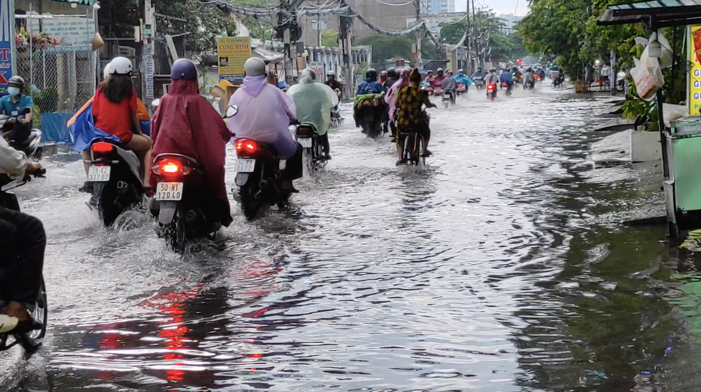 Rất nhiều phương tiện buộc phải lội qua dòng nước để về nhà, cả đoạn đường qua đây bị kẹt cứng.