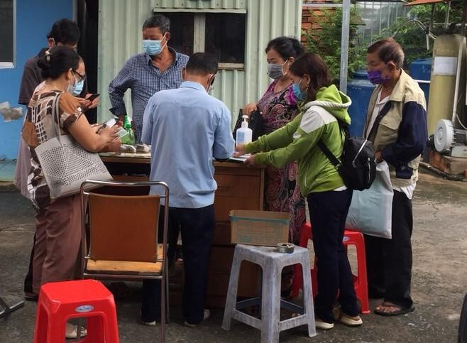 Người dân tranh thủ rửa tay sát khuẩn trước phòng khám Đa khoa Nam Sài Gòn nhưng lại quên giữ khoảng cách. Ảnh: Internet