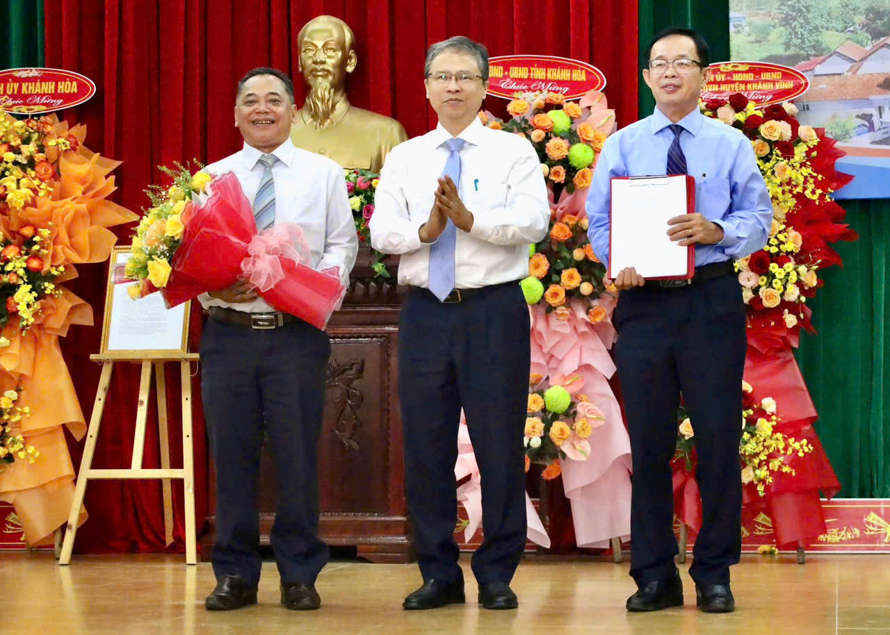 Đại diện lãnh đạo UBND tỉnh Khánh Hòa trao quyết định phê duyệt quy hoạch xây dựng vùng huyện Khánh Vĩnh cho lãnh đạo địa phương.