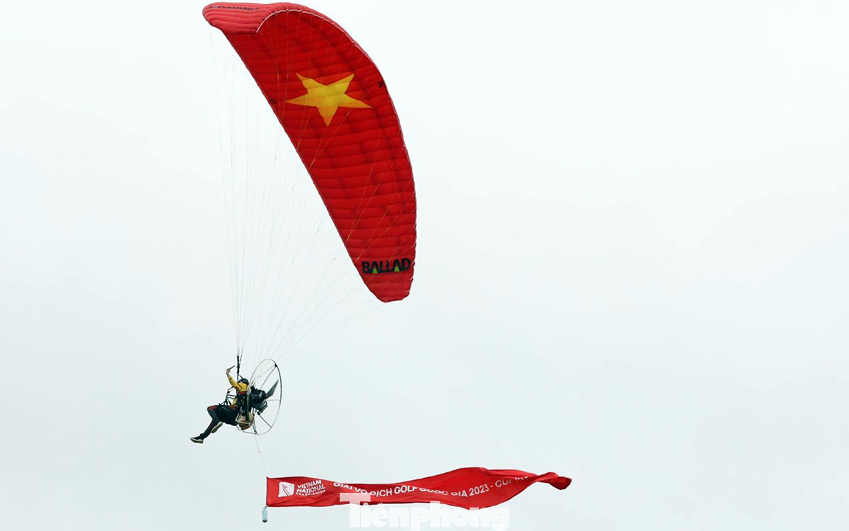Phi công dẫn đầu đoàn du lượn gắn cờ đỏ sao vàng kèm lá cờ Giải Vô địch Golf Quốc gia năm 2023 - Cúp VinFast chào mừng nhà vô địch và chúc mừng các golfer sau 4 ngày tranh tài.