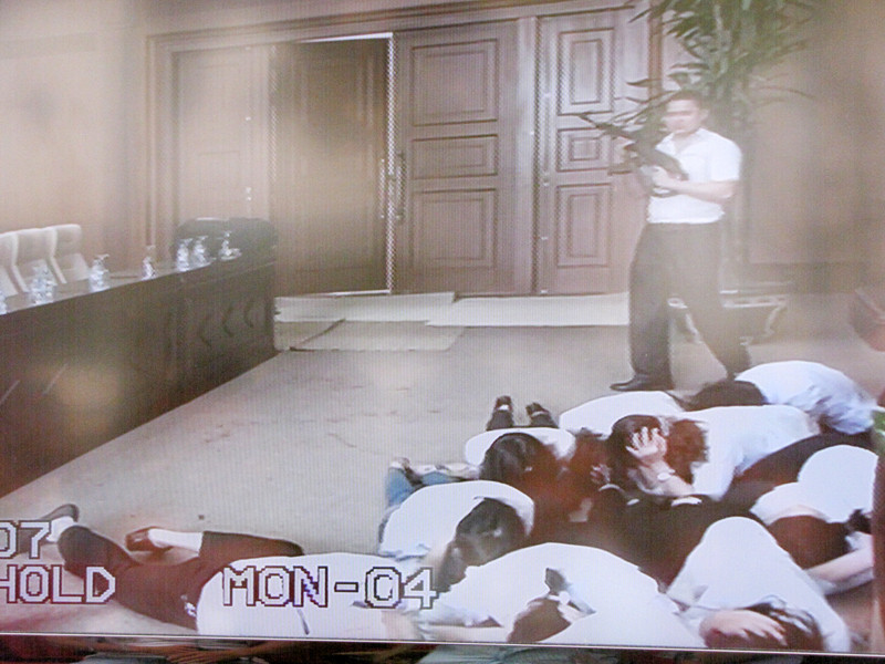 Sau đó, một tên bên ngoài cảnh giới, 4 tên xông vào khống chế ngân hàng, yêu cầu thủ quỹ mở két đưa tiền, vàng. Khi nghe súng nổ, thủ quỹ đã kịp thời ấn nút hệ thống chuông báo động kết nối trực tiếp với lực lượng công an sở tại