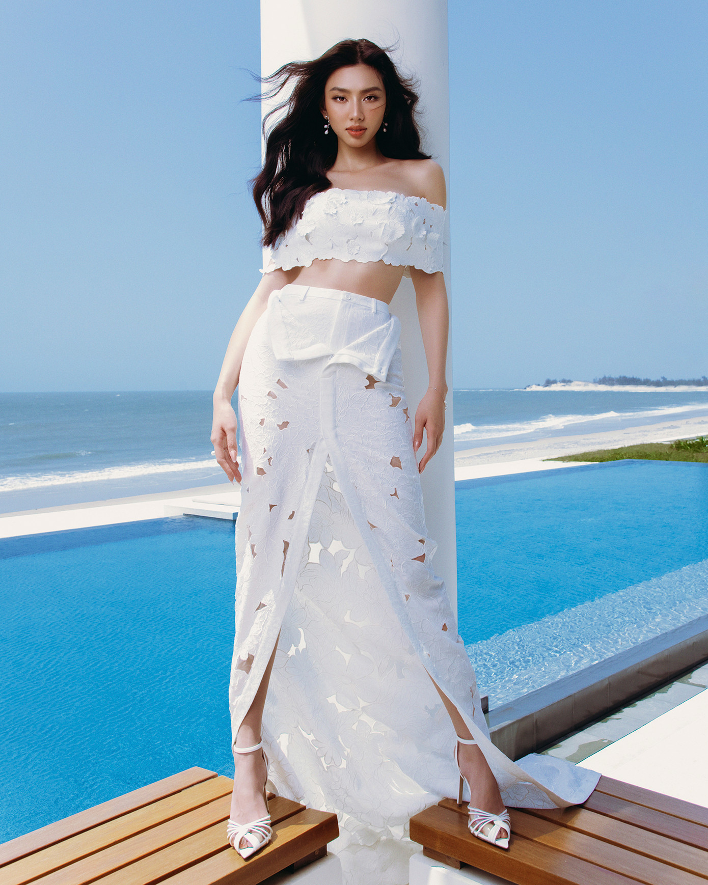 Bộ ảnh được thực hiện ở không gian thoáng đãng của biển cả. Thùy Tiên khoe vóc dáng quyến rũ trong những thiết kế chất liệu xuyên thấu, tông màu trắng chủ đạo.