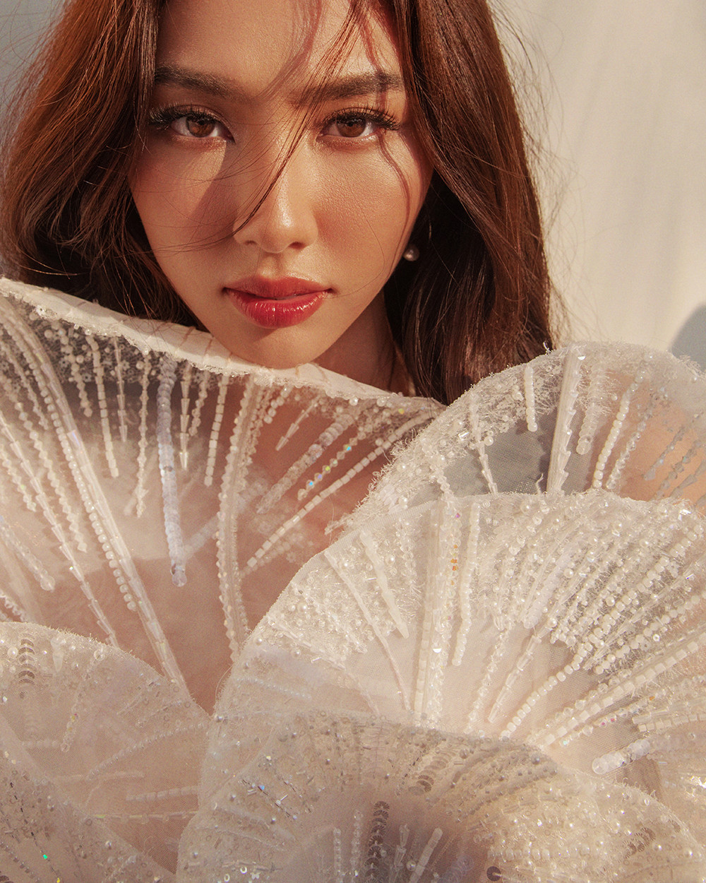 Tông màu trắng với chất liệu voan, ren xuyên thấu được dựng phom 3D cầu kỳ mang lại vẻ ngoài tinh khiết, ngọt ngào nhưng cũng không kém phần quyến rũ cho Thùy Tiên.