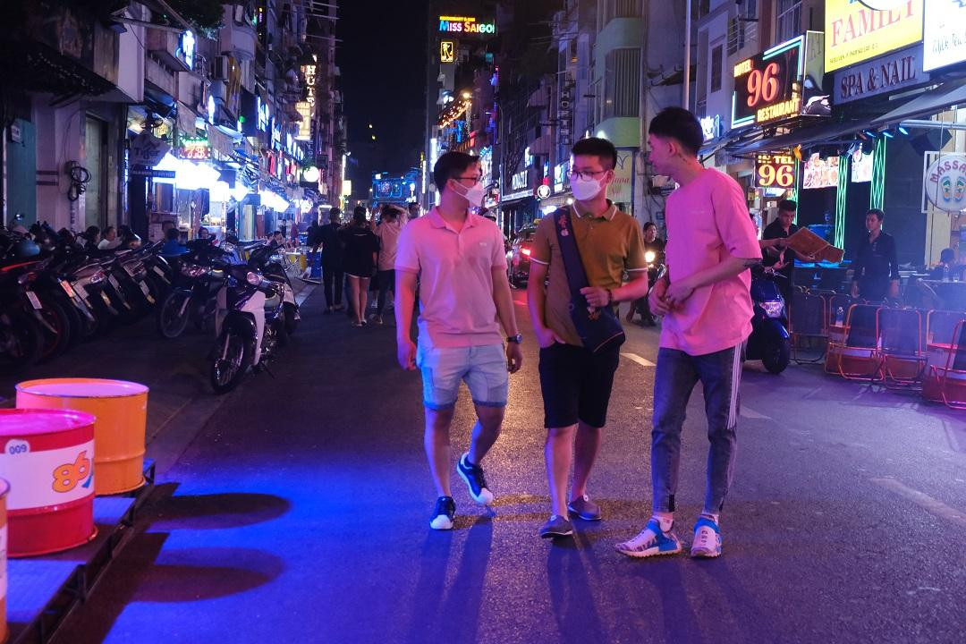 Nhân viên quán ở phố Tây Bùi Viện chào mời khách vào quán. Nhân viên quán ở phố Tây Bùi Viện chào mời khách vào quán.