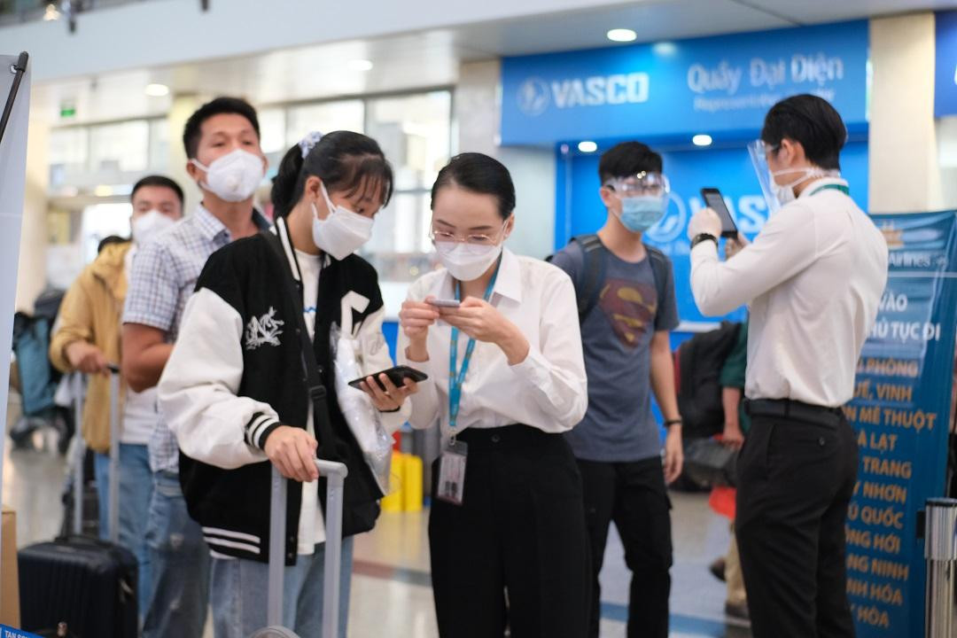 Nhân viên hãng hàng không hướng dẫn hành khách khai báo y tế.