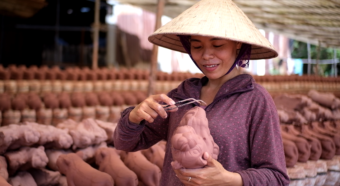 Chị Hợp đang gọt tỉa phần dư thừa do tháo khuôn cho sản phẩm "Hổ ngậm ngọc". Chị Hợp đang gọt tỉa phần dư thừa do tháo khuôn cho sản phẩm "Hổ ngậm ngọc".