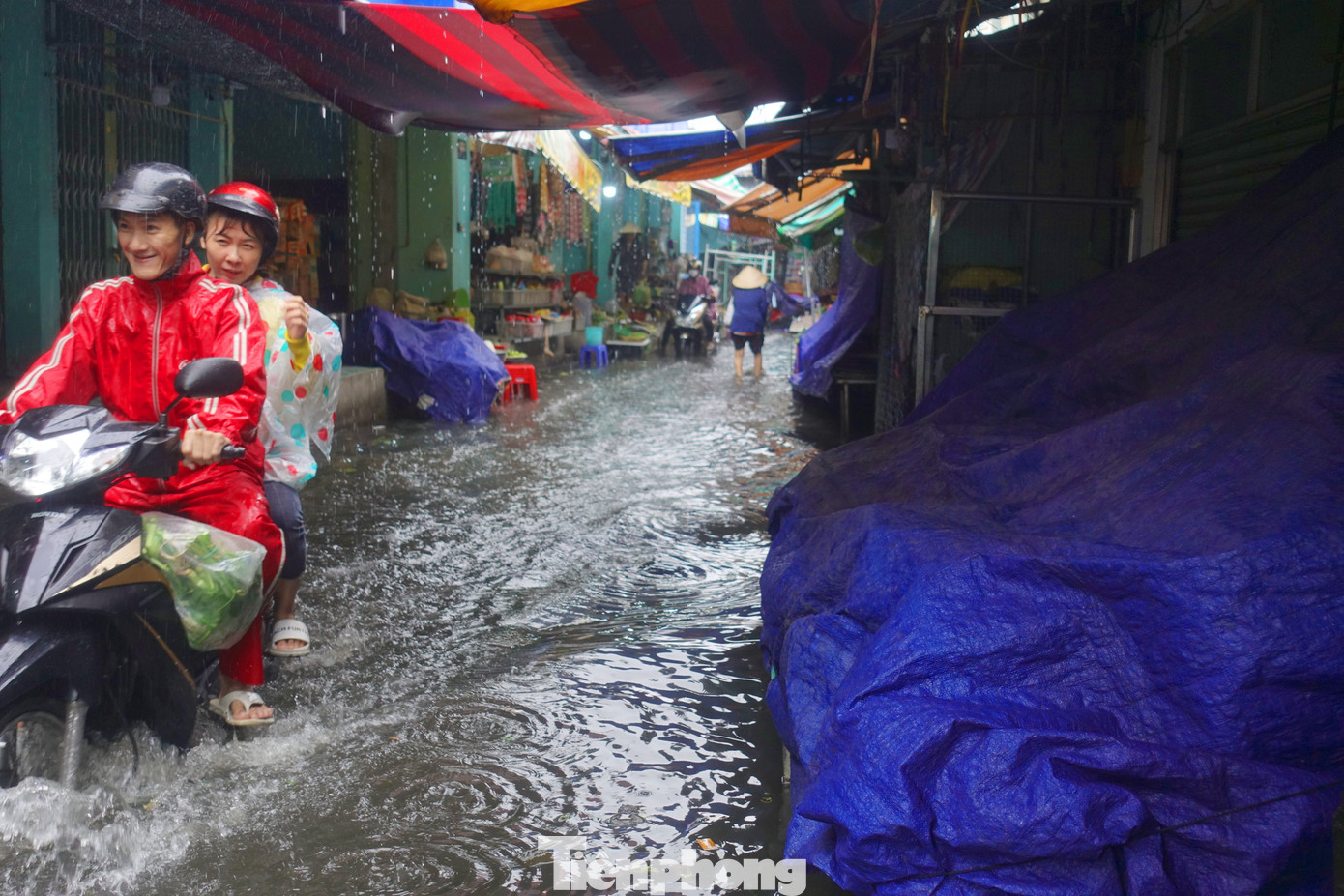Giao thông ra vào chợ gặp nhiều khó khăn vì tình trạng ngập úng. Ảnh: Hữu Huy
