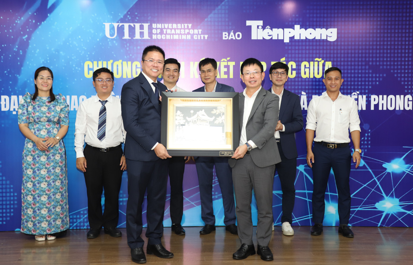 Lãnh đạo UTH và báo Tiền Phong trao quà kỷ niệm tại buổi ký kết.