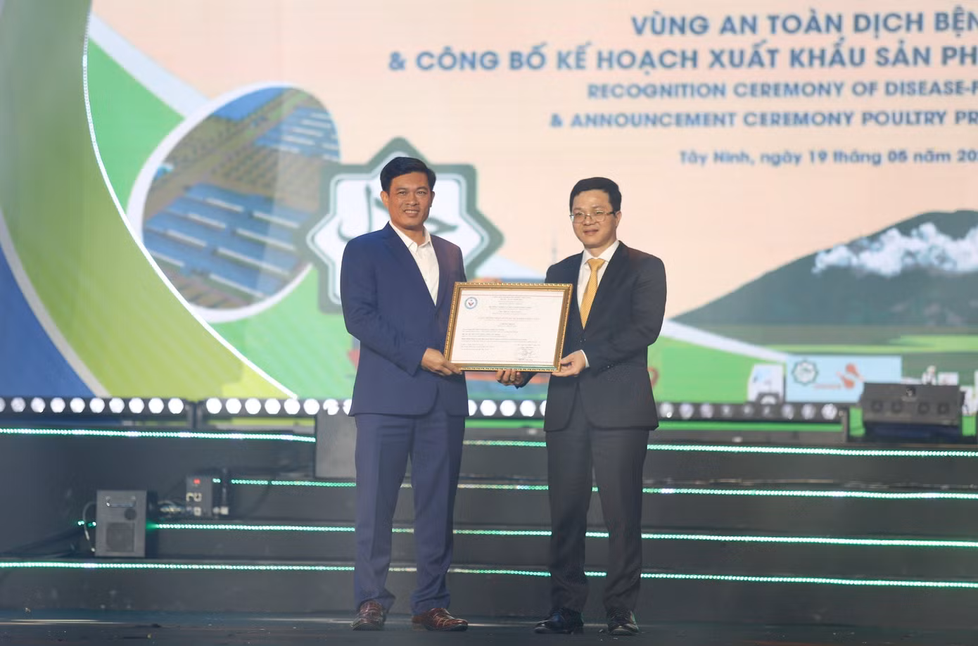 Ông Võ Hồng Sang, Chủ tịch UBND huyện Tân Châu (trái) nhận Giấy chứng nhận vùng an toàn dịch bệnh.