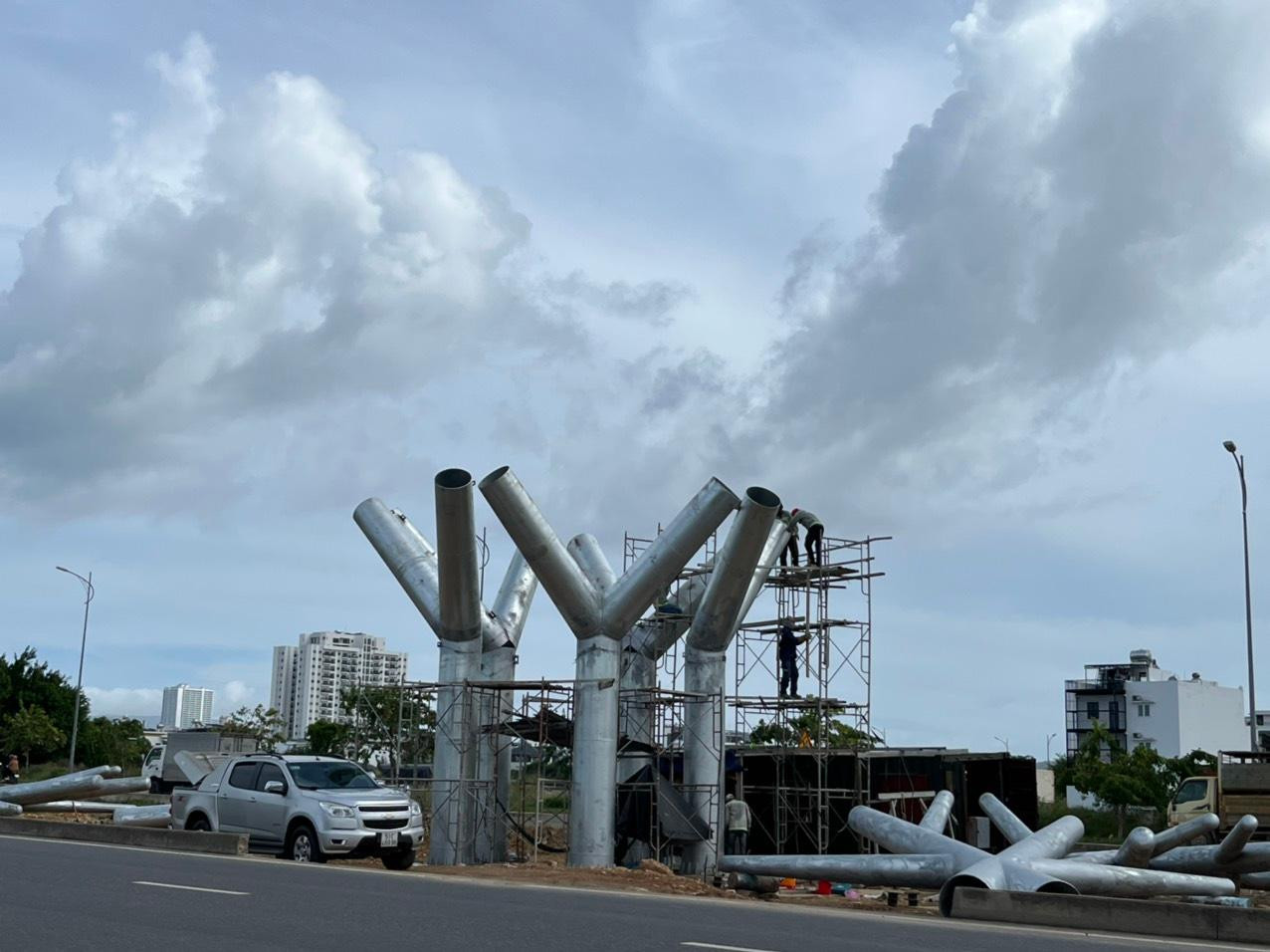 Công nhân đang thi công 5 trụ sắt làm biểu tượng trên đường Võ Nguyên Giáp. (Ảnh L.H)