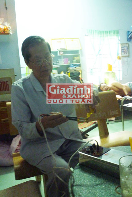 Thầy thuốc Ba Phúc đang khám chữa bệnh cho bệnh nhân bằng phương pháp châm trực dược. (Ảnh: K. Vân)