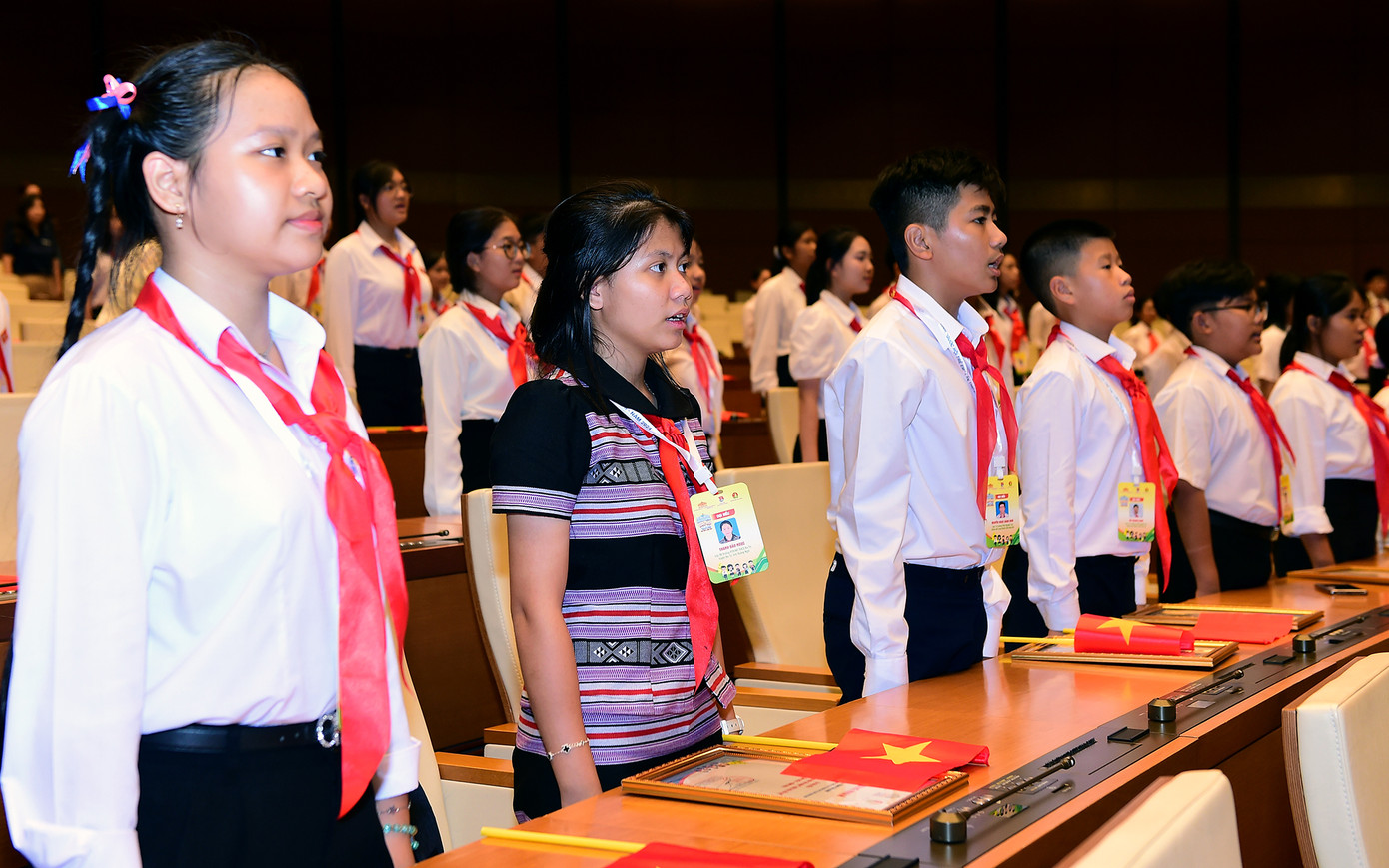 Các đại biểu thực hiện nghi lễ chào cờ mở đầu phiên khai mạc chương trình phiên họp giả định "Quốc hội trẻ em". Ảnh: Xuân Tùng
