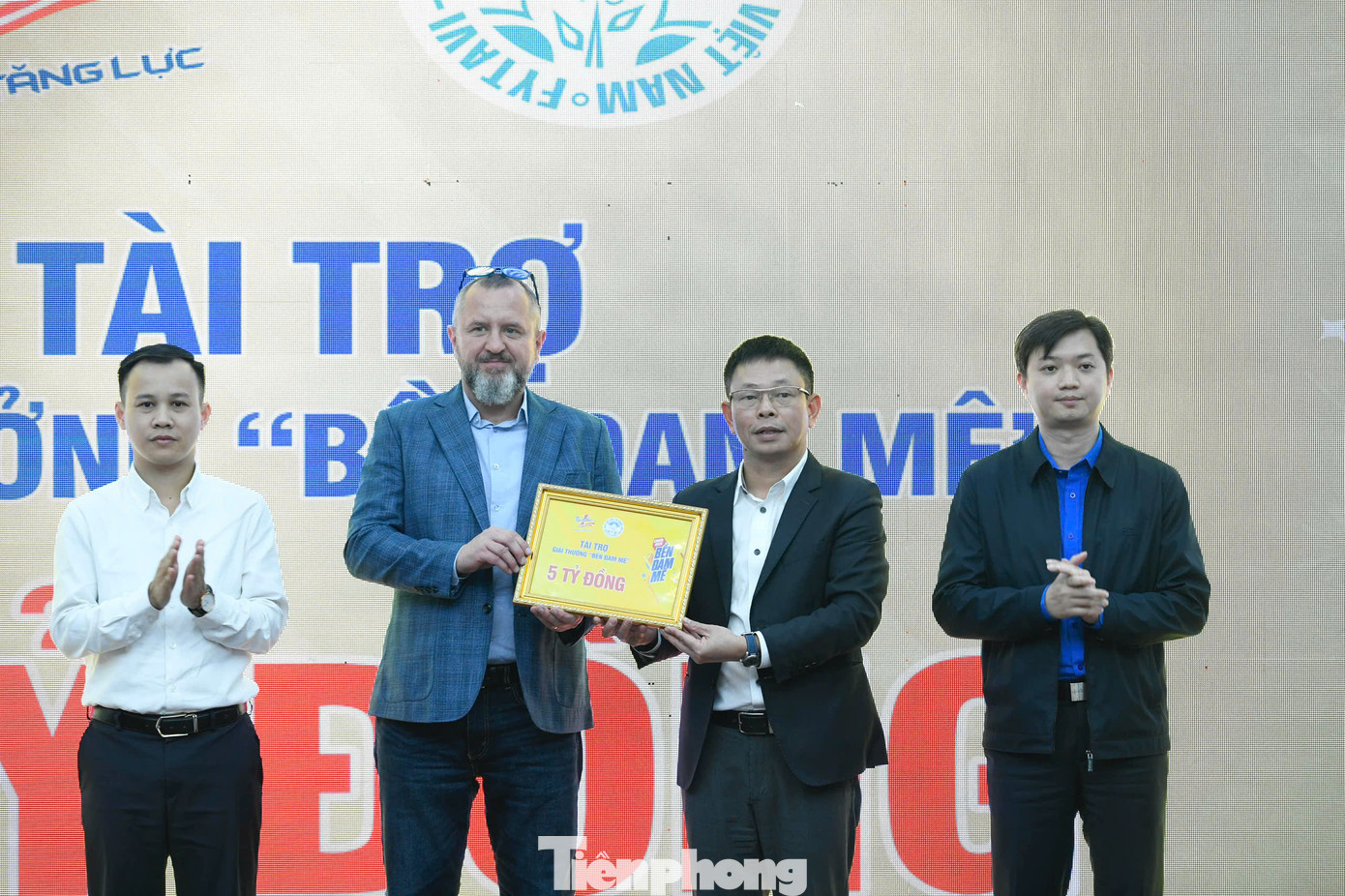 Ông Andrzej Tomasz Bialasiewicz trao biểu trưng tài trợ 5 tỷ đồng cho nhà báo Phùng Công Sưởng - Tổng Biên tập Báo Tiền Phong, Giám đốc Trung tâm Quỹ Hỗ trợ Tài năng trẻ Việt Nam.