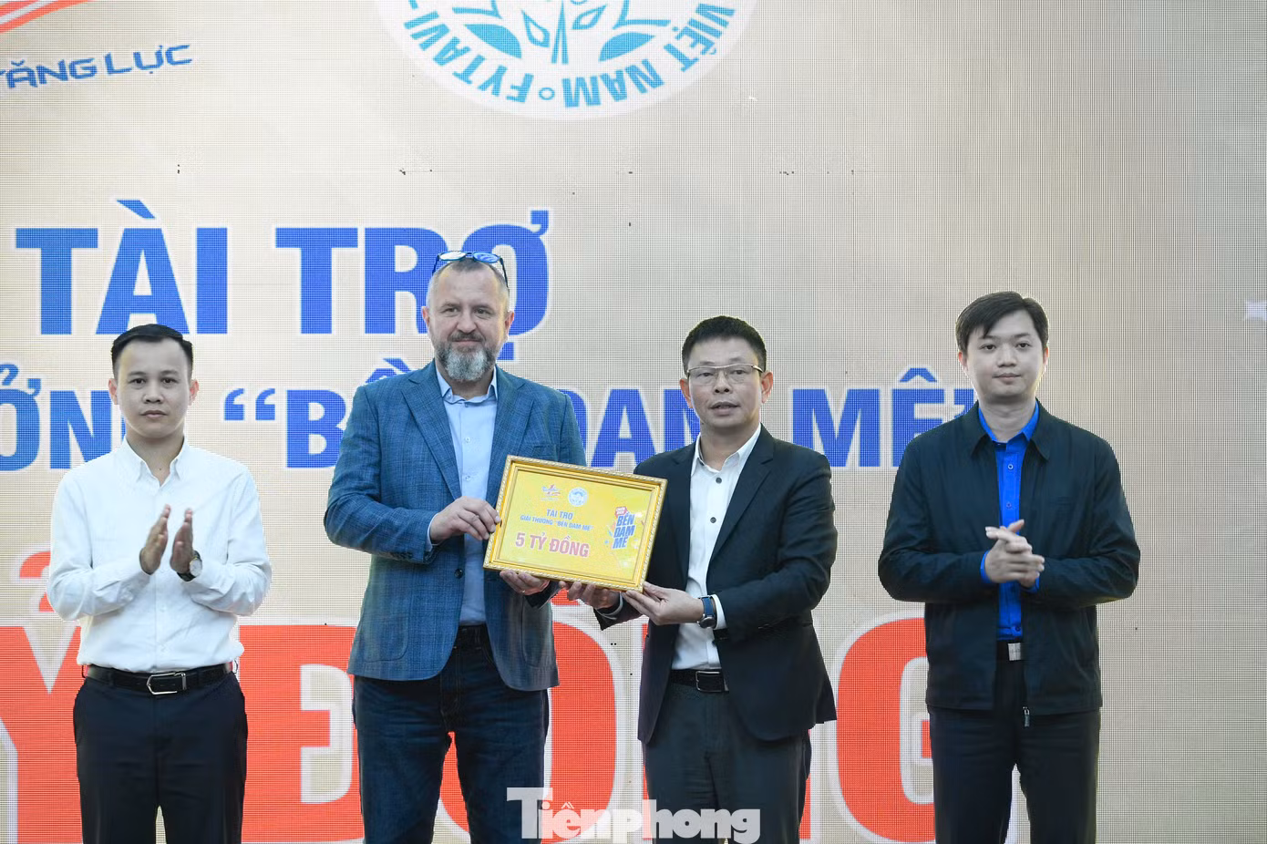 Ông Andrzej Tomasz Bialasiewicz trao biểu trưng tài trợ 5 tỷ đồng cho nhà báo Phùng Công Sưởng - Tổng Biên tập Báo Tiền Phong, Giám đốc Trung tâm Quỹ Hỗ trợ Tài năng trẻ Việt Nam.