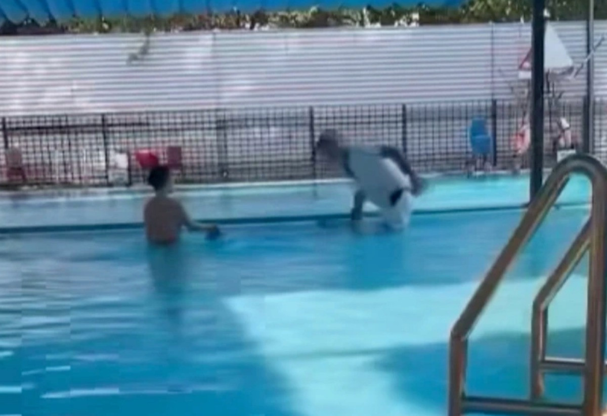 Hình ảnh anh Đ. dìm bé trai xuống bể bơi. Ảnh cắt từ clip. Hình ảnh anh Đ. dìm bé trai xuống bể bơi. Ảnh cắt từ clip.